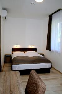 A bed or beds in a room at F&M Apartman
