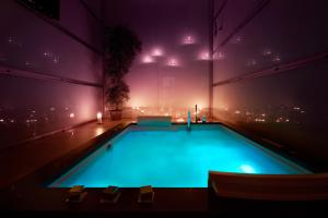 a swimming pool in a building at night at Hotel Senator Konferencje & SPA in Starachowice
