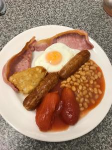 a plate of breakfast food with eggs beans and bacon at The Island & Fairfield in Douglas