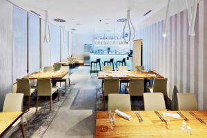 a dining room with wooden tables and chairs at Fairhotel in Brno