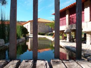 a pool of water in front of a building at Casa D`Auleira in Ponte da Barca