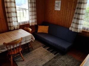Zimmer mit Sofa, Tisch und Fenster in der Unterkunft Apartments Balon in Kranjska Gora