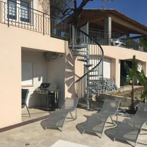 a patio with chairs and a staircase next to a house at Villa l'Olivier in Cagnes-sur-Mer