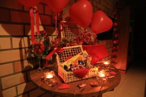 a table with balloons and a basket of food and candles at Pousada Waikiki in Praia do Rosa +89 photos