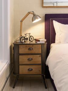 a nightstand with a bike on it next to a bed at 5b North Parade Avenue in Oxford