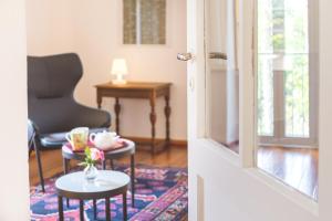 a living room with a chair and a table at Il guscio in Cadro +5 photos
