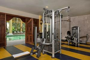 a fitness room with a swimming pool and a gym at Iberostar Grand Paraiso in Puerto Morelos
