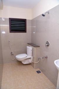 a bathroom with a toilet and a sink at SGRT Residency in Vellore