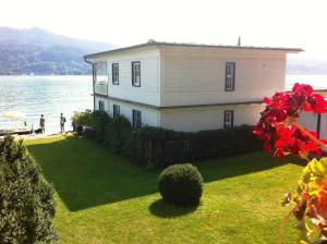 a house on the shore of a body of water at Seehaus Jamek in Pörtschach am Wörthersee