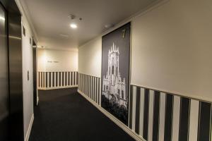 a hallway with a large picture of a building at Quest Auckland Serviced Apartments in Auckland