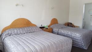 Postel nebo postele na pokoji v ubytování Coachman Motel