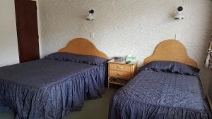 Postel nebo postele na pokoji v ubytování Coachman Motel