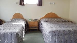 Postel nebo postele na pokoji v ubytování Coachman Motel