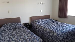 Postel nebo postele na pokoji v ubytování Coachman Motel