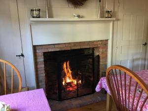 a fireplace that has a fire place in it at Black Boar Inn Ogunquit in Ogunquit