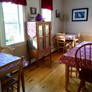 a room with a table, chairs, and a window at Black Boar Inn Ogunquit in Ogunquit
