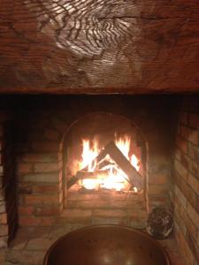 a fire place with a brick wall and a stone fireplace at Black Boar Inn Ogunquit in Ogunquit