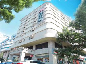 a large white building with a sign on it at Jingjiang Inn Taiyuan Fuxi Street Wanda Plaza in Taiyuan