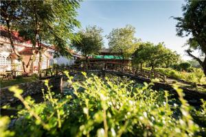 a bridge over a river in a park at Xuanmai Garden Resort in Pakse