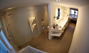 a bathroom with a shower and a sink and a mirror at Stock Apartments in Mayrhofen