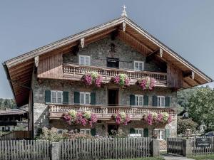 ein Haus mit Blumen auf der Vorderseite in der Unterkunft Schneiderwirt in Nußdorf am Inn