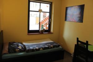 a room with a small bed in front of a window at L&L Skaters Home in Langenlipsdorf