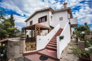 a house with a staircase leading up to it at Casa Vacanza il Mandorlo in Domusnovas