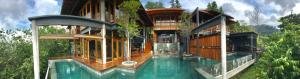 a house with a swimming pool in front of it at The Shorea in Seremban