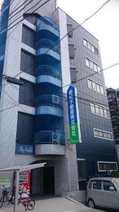 un edificio con una señal delante de él en Kurashiki Base Inarimachi en Kurashiki