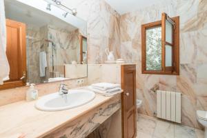a bathroom with a sink and a mirror at Can Boira in Portocolom +29 photos