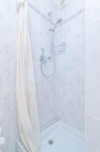 a shower with a shower curtain in a bathroom at Can Nicolau in Colonia de Sant Pere