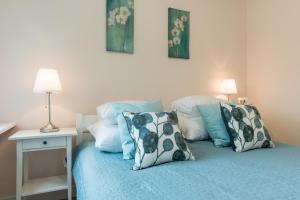 sypialnia z łóżkiem i poduszkami w obiekcie P&O Apartments Kasprzaka w Warszawie