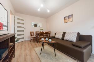 salon z kanapą i stołem w obiekcie P&O Apartments Kasprzaka w Warszawie