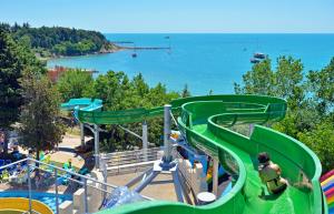 a slide at a water park with people on it at Sol Nessebar Bay All Inclusive in Nesebar