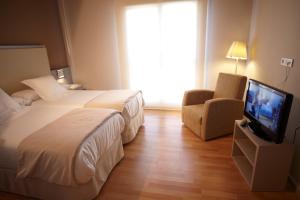 Postel nebo postele na pokoji v ubytování Hotel Nagusi