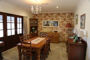 a dining room with a wooden table and chairs at BellbirdHill Bed & Breakfast in Wingham