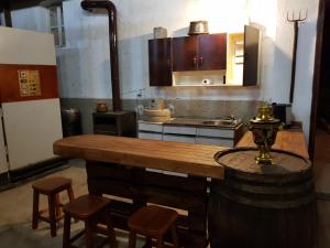 Sadovo的住宿－Guest House Sadovo，厨房配有木台面和一些凳子