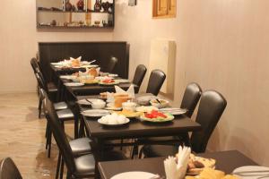 a dining room with a long table filled with food at Hotel Lions in Tbilisi City