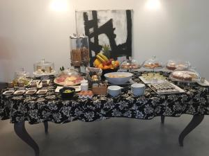 a table with a buffet of food on it at Teku Sardinia Boutique Hotel in Bari Sardo