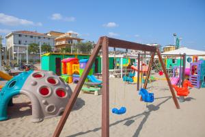 a playground in the sand in a beach at Residence Maryel in Rimini