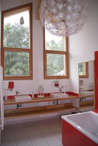 a bathroom with three sinks and a large mirror at Chalet ChampBenoit in Valmorel