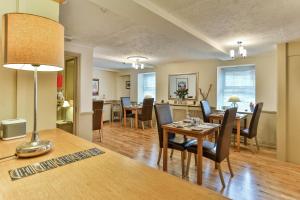 a dining room and living room with a table and chairs at The Coach House Brecon in Brecon