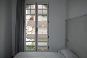 Ένα ή περισσότερα κρεβάτια σε δωμάτιο στο Apartamentos Senabre Palais