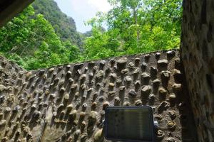 a wall with a laptop sitting on top of it at Khao Sok Green Mountain View in Khao Sok National Park