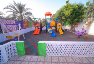 a childrens playground with slides and play equipment at Fujairah Hotel & Resort in Fujairah