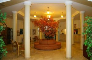 a lobby with a fountain with a tree in it at Fujairah Hotel & Resort in Fujairah +37 photos