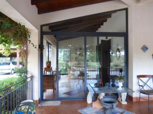 a screened in porch with a glass door at Villa Amalia - mansarda in Cinisi