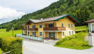 a yellow house in the middle of a mountain at Sunside in Flachau