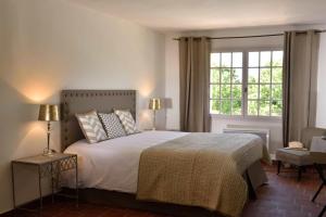a bedroom with a large bed and a window at Domaine Le Bois Des Dames in Chantemerle-lès-Grignan +50 photos