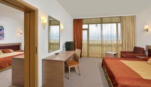 A bed or beds in a room at Sol Nessebar Palace All Inclusive